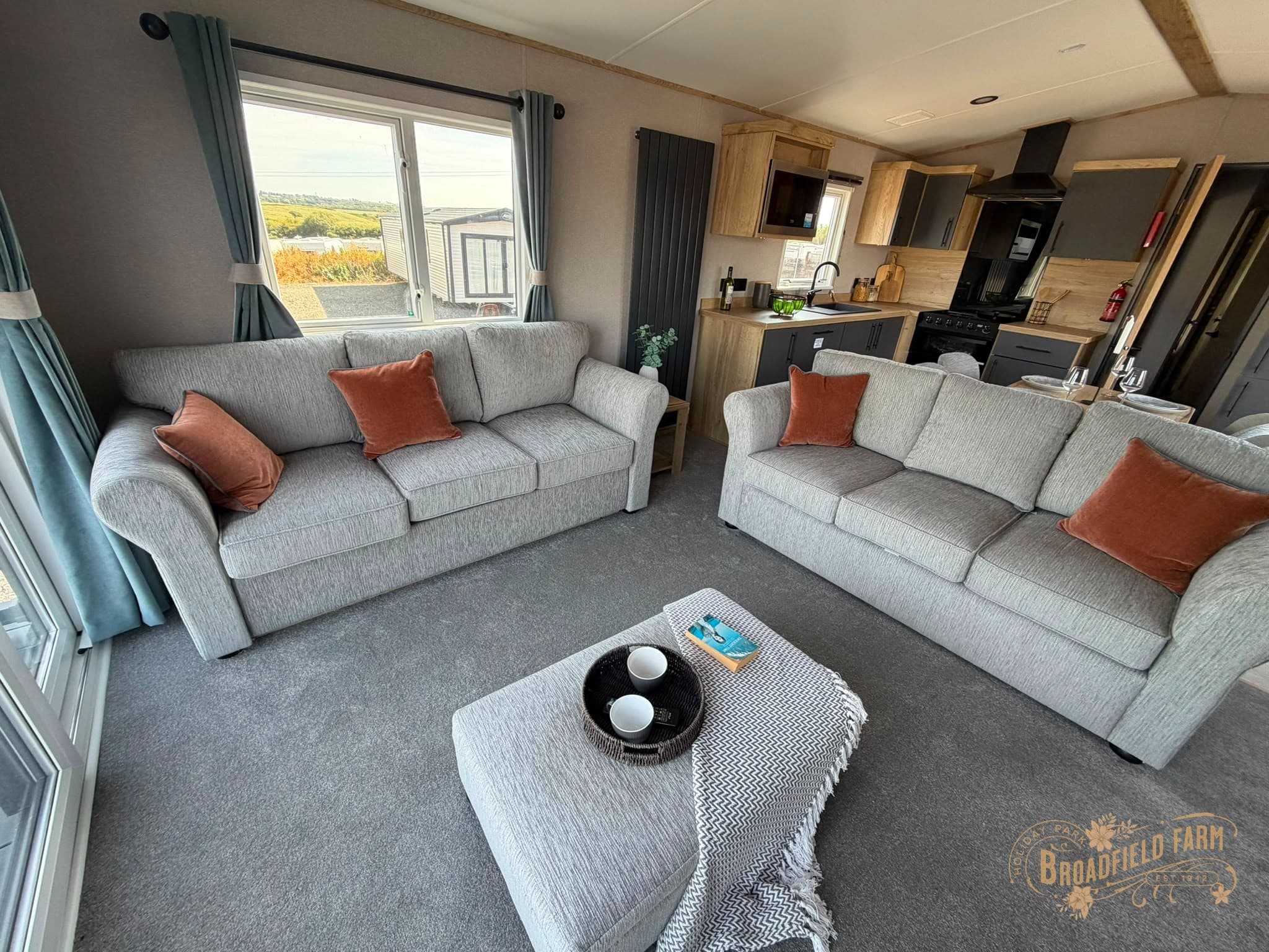 Open-plan lounge with two sofas in the 2026 ABI Broughton at Broadfield Farm