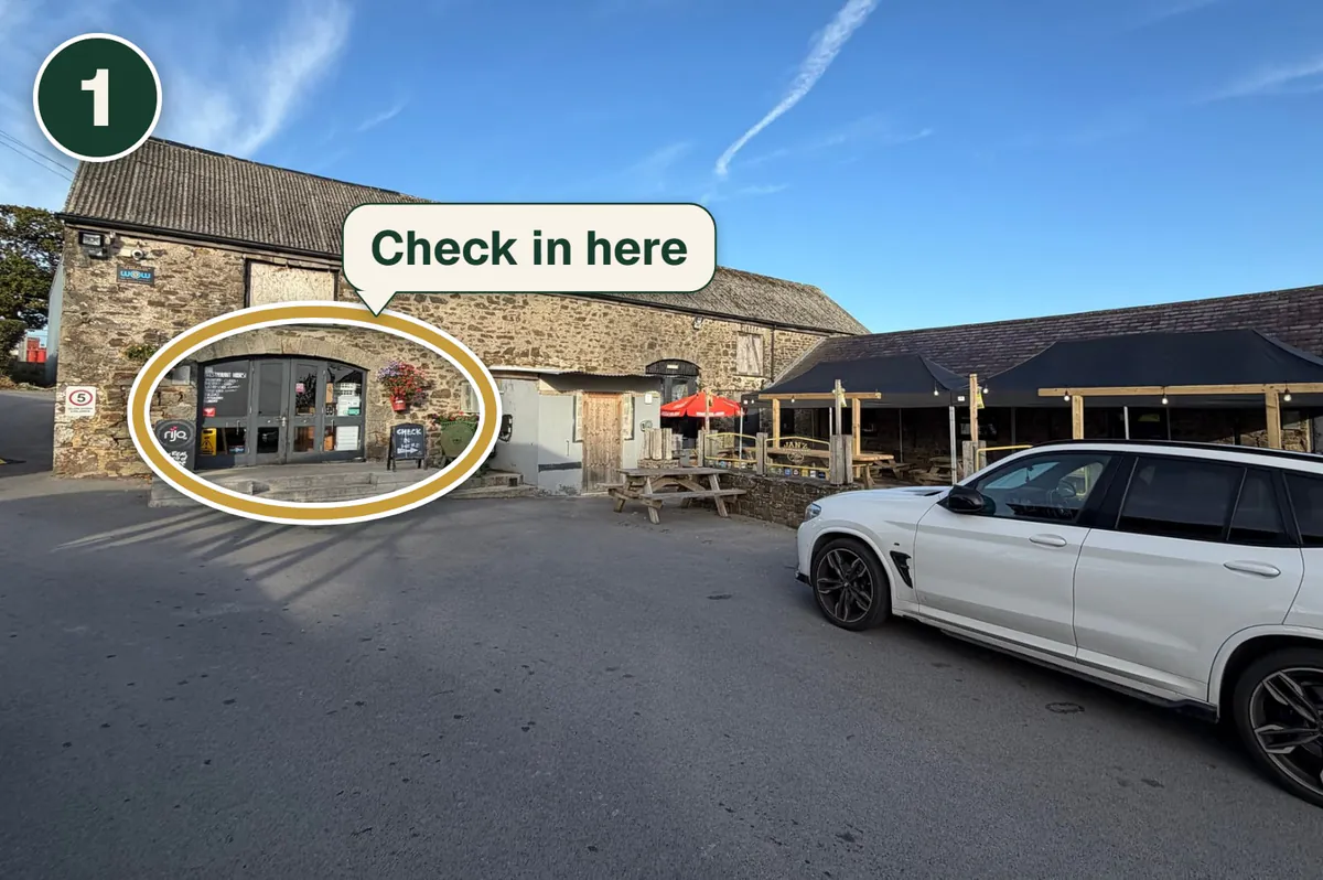Jan’z from the car park, with its front doors ringed in gold and a label saying Check in here.